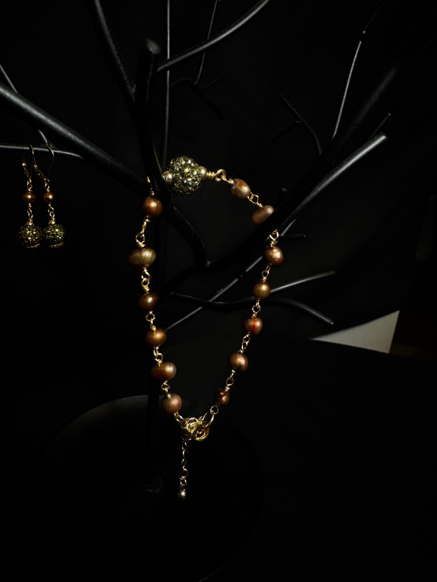 Jewelry set with necklace and earrings on dark background