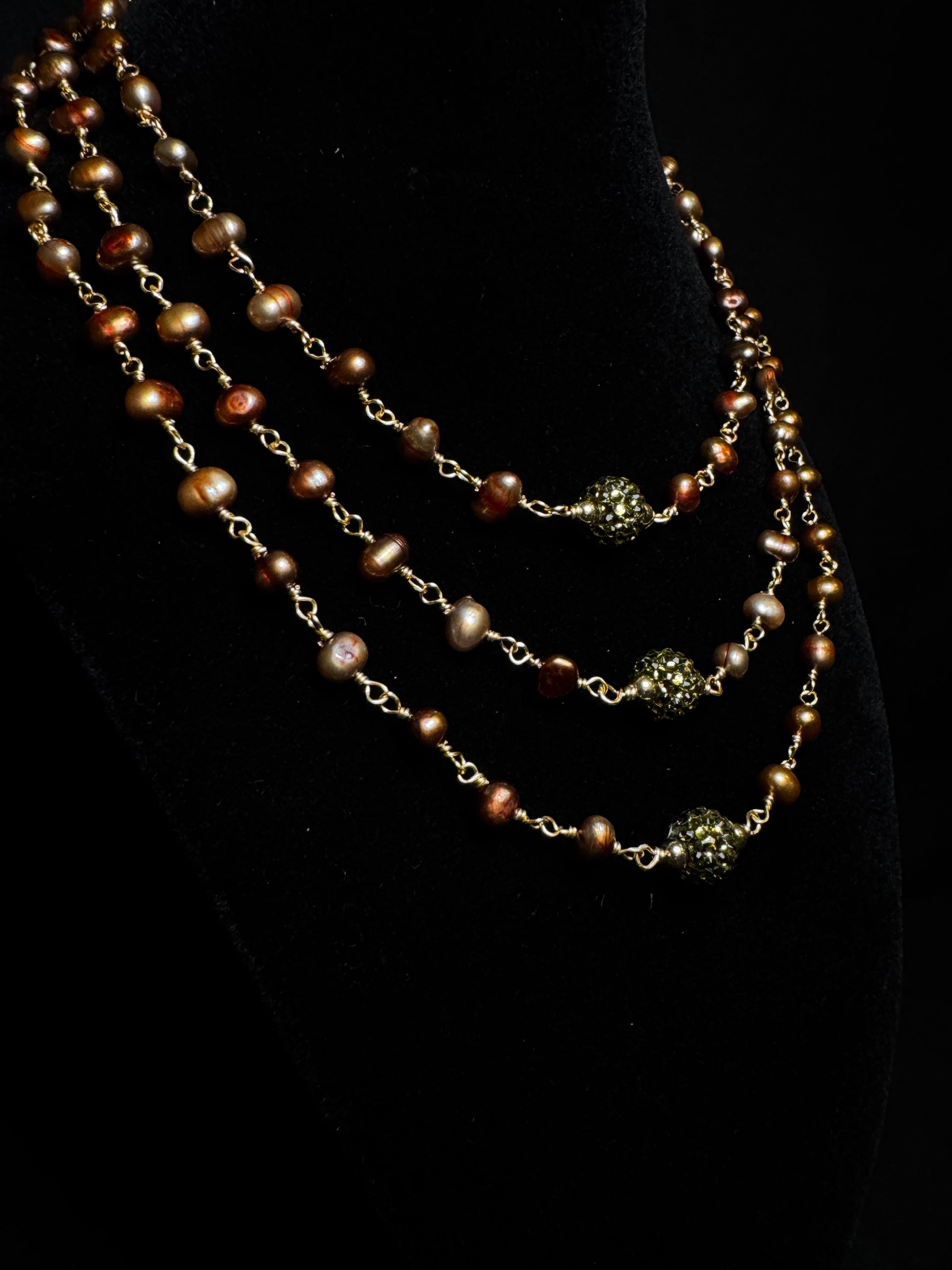Multi-layered pearl necklace on a black background